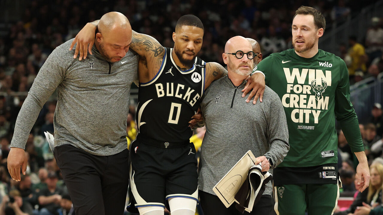 MILWAUKEE, WISCONSIN - APRIL 27: Damian Lillard #0 of the Milwaukee Bucks is helped off the court after an apparent injury during the first quarter in Game Four of the Eastern Conference First Round NBA Playoffs against the Indiana Pacers at Fiserv Forum on April 27, 2025 in Milwaukee, Wisconsin.
