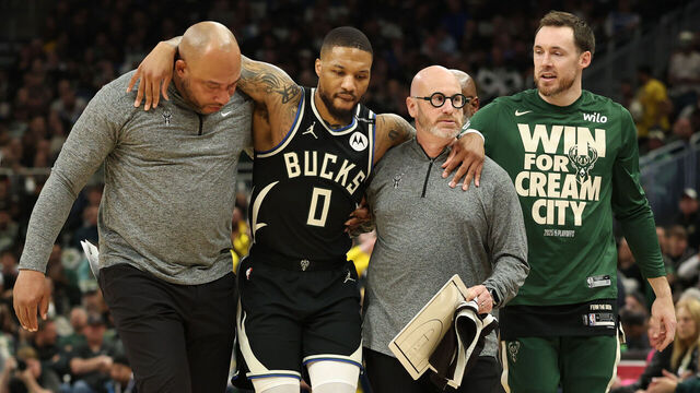 MILWAUKEE, WISCONSIN - APRIL 27: Damian Lillard #0 of the Milwaukee Bucks is helped off the court after an apparent injury during the first quarter in Game Four of the Eastern Conference First Round NBA Playoffs against the Indiana Pacers at Fiserv Forum on April 27, 2025 in Milwaukee, Wisconsin.
