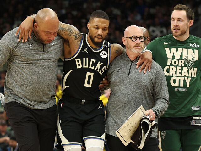 MILWAUKEE, WISCONSIN - APRIL 27: Damian Lillard #0 of the Milwaukee Bucks is helped off the court after an apparent injury during the first quarter in Game Four of the Eastern Conference First Round NBA Playoffs against the Indiana Pacers at Fiserv Forum on April 27, 2025 in Milwaukee, Wisconsin.
