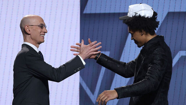 NEW YORK, NEW YORK - JUNE 25: Dylan Harper (R) shakes hands with NBA commissioner Adam Silver (L) after being drafted second overall by the San Antonio Spurs during the first round of the 2025 NBA Draft at Barclays Center on June 25, 2025 in the Brooklyn borough of New York City. NOTE TO USER: User expressly acknowledges and agrees that, by downloading and/or using this photograph, user is consenting to the terms and conditions of the Getty Images License Agreement.