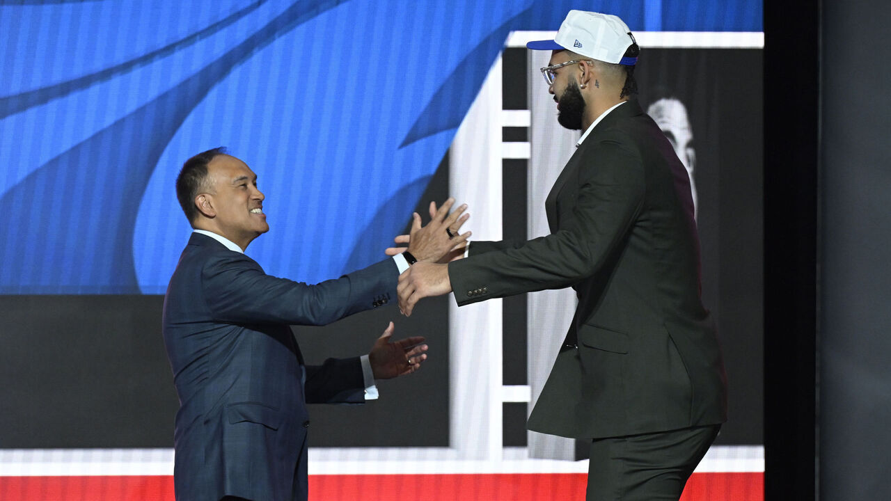 BROOKLYN, NY - JUNE 26: NBA Deputy Commissioner Mark Tatum shakes hands with Johni Broome after being drafted thirty fifth overall during the 2025 NBA Draft - Round Two on June 26, 2025 at Barclays Center in Brooklyn, New York. Mandatory Copyright Notice: Copyright 2025 NBAE