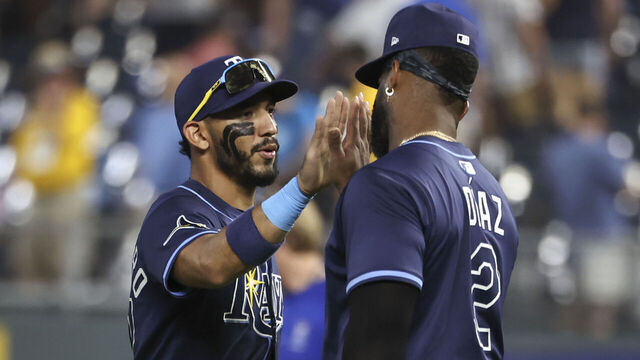 KANSAS CITY, MO - JUNE 24: Tampa Bay Rays first base Yandy Díaz (2) and third base Junior Caminero (13) celebrate a win after an MLB game between the Tampa Bay Rays and Kansas City Royals on June 24, 2025 at Kauffman Stadium in Kansas City, MO.