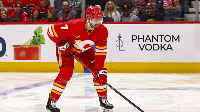 CALGARY, AB - APRIL 11: Kevin Bahl #7 of the Calgary Flames prepares to face off against the Minnesota Wild at Scotiabank Saddledome on April 11, 2025 in Calgary, Alberta, Canada.