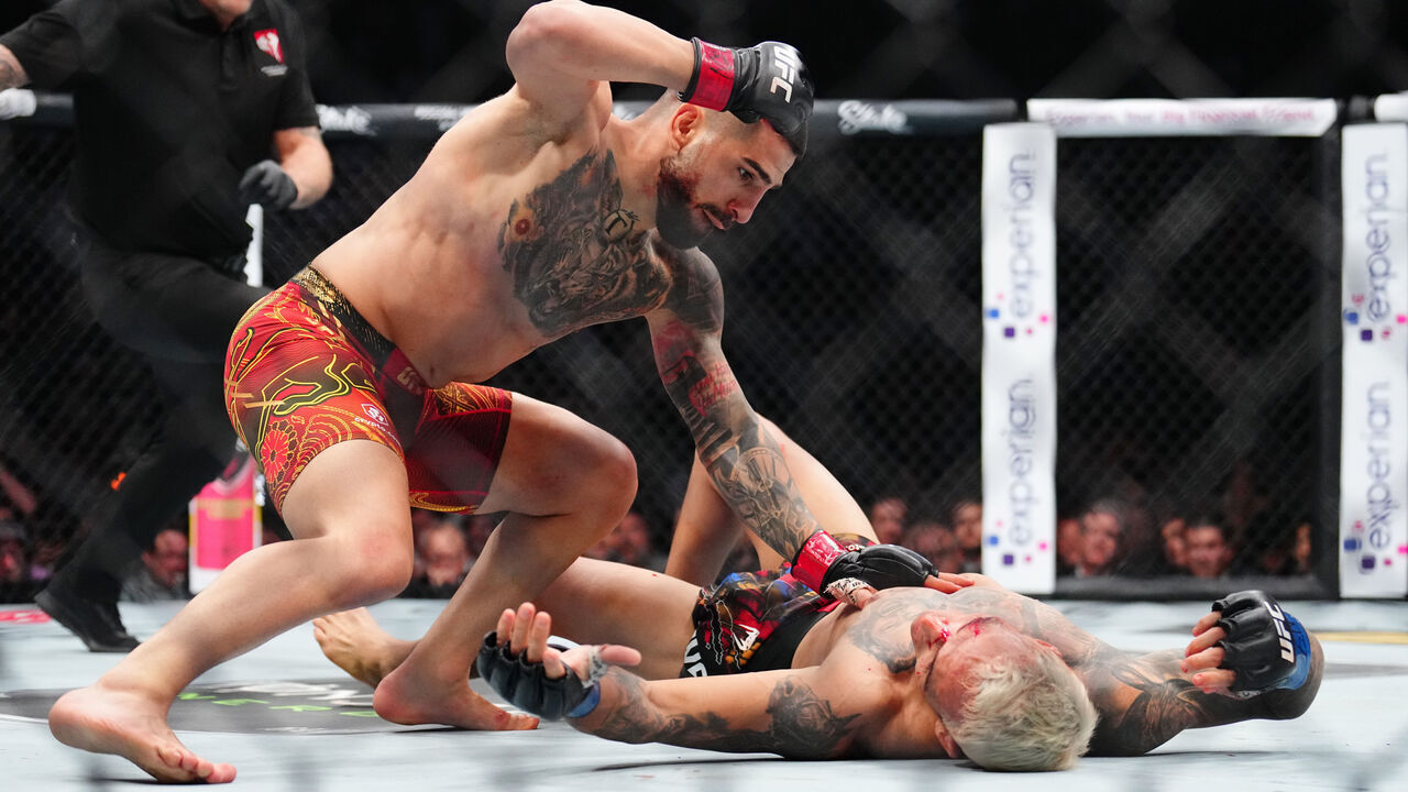 LAS VEGAS, NEVADA - JUNE 28: (L-R) Ilia Topuria of Spain strikes Charles Oliveira of Brazil in the UFC lightweight championship bout during the UFC 317 event at T-Mobile Arena on June 28, 2025 in Las Vegas, Nevada.