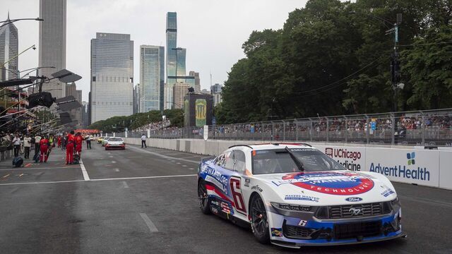 CHICAGO, IL - JULY 07: Brad Keselowski (#6 RFK Racing Elk Grove Village Ford) exits pit row with the Chicago Skyline during the NASCAR Cup Series Grant Park 165 at the Chicago Street Circuit on July 07, 2024 in Chicago, Illinois.