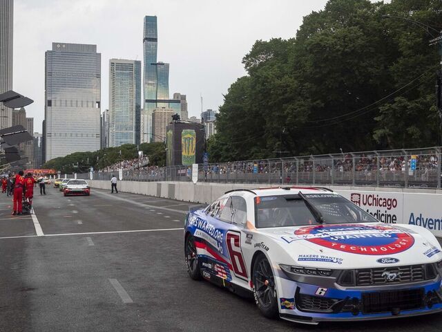 CHICAGO, IL - JULY 07: Brad Keselowski (#6 RFK Racing Elk Grove Village Ford) exits pit row with the Chicago Skyline during the NASCAR Cup Series Grant Park 165 at the Chicago Street Circuit on July 07, 2024 in Chicago, Illinois.