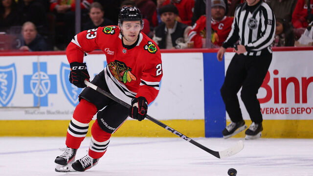 CHICAGO, IL - APRIL 12: Philipp Kurashev #23 of the Chicago Blackhawks controls the puck during the third period against the Winnipeg Jets on April 12. 2025 at the United Center in Chicago, Illinois.