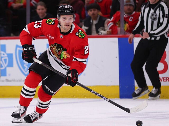 CHICAGO, IL - APRIL 12: Philipp Kurashev #23 of the Chicago Blackhawks controls the puck during the third period against the Winnipeg Jets on April 12. 2025 at the United Center in Chicago, Illinois.