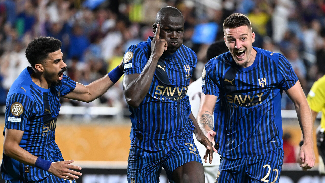 Al Hilal's Senegalese defender #03 Kalidou Koulibaly (C) celebrates with teammates Saudi defender #78 Ali Lajami and Serbian midfielder #22 Sergej Milinkovic-Savic after scoring his team's third goal during the FIFA Club World Cup 2025 round of 16 football match between England's Manchester City and Saudi's Al-Hilal at the Camping World stadium in Orlando on June 30, 2025.
