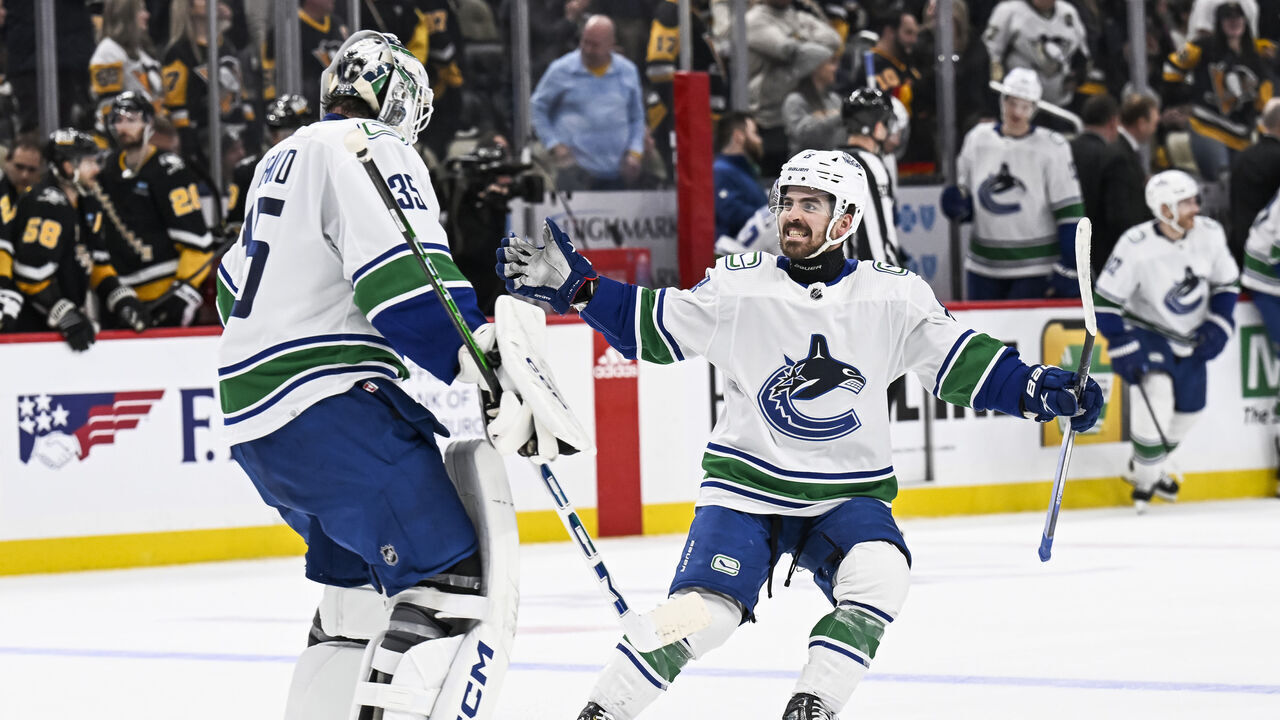 PITTSBURGH, PA - JANUARY 11: Vancouver Canucks right wing Conor Garland (8) and Vancouver Canucks goaltender Thatcher Demko (35) celebrate a win during the overtime period in the NHL game between the Pittsburgh Penguins and the Vancouver Canucks on January 11, 2024, at PPG Paints Arena in Pittsburgh, PA.