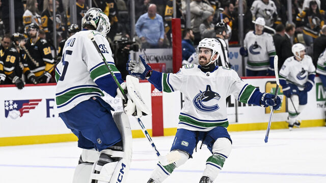 PITTSBURGH, PA - JANUARY 11: Vancouver Canucks right wing Conor Garland (8) and Vancouver Canucks goaltender Thatcher Demko (35) celebrate a win during the overtime period in the NHL game between the Pittsburgh Penguins and the Vancouver Canucks on January 11, 2024, at PPG Paints Arena in Pittsburgh, PA.