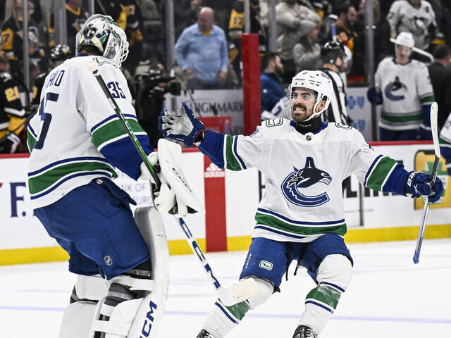PITTSBURGH, PA - JANUARY 11: Vancouver Canucks right wing Conor Garland (8) and Vancouver Canucks goaltender Thatcher Demko (35) celebrate a win during the overtime period in the NHL game between the Pittsburgh Penguins and the Vancouver Canucks on January 11, 2024, at PPG Paints Arena in Pittsburgh, PA.