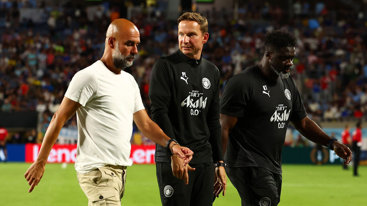 ORLANDO, FLORIDA - JUNE 30: Manchester City coach Josep Guardiola (L) leaves the field at half-time talking to coaches Pep Lijnders (C) and Kolo Toure during the FIFA Club World Cup 2025 round of 16 match between Manchester City and Al-Hilal at Camping World Stadium on June 30, 2025 in Orlando, Florida.