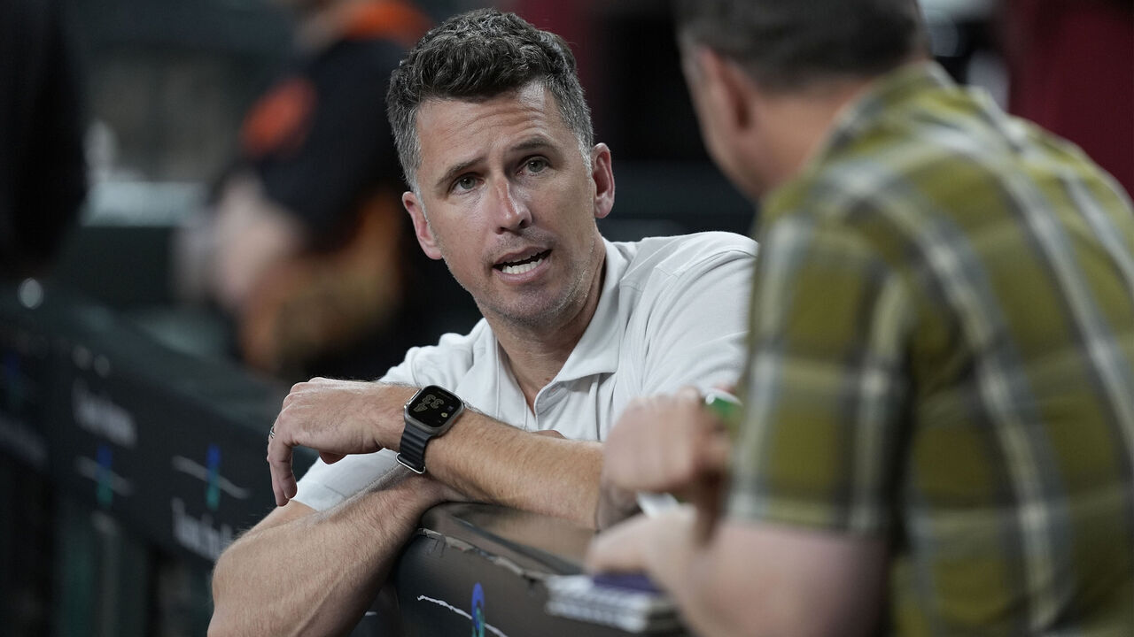 PHOENIX, ARIZONA - JUNE 30: President of baseball operations Buster Posey of the San Francisco Giants looks on in a game against the Arizona Diamondbacks at Chase Field on June 30, 2025 in Phoenix, Arizona.