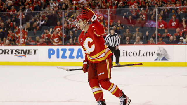 CALGARY, CANADA - APRIL 15: Morgan Frost #16 of the Calgary Flames celebrates his overtime goal against the Vegas Golden Knights at the Scotiabank Saddledome on April 15, 2025, in Calgary, Alberta, Canada.