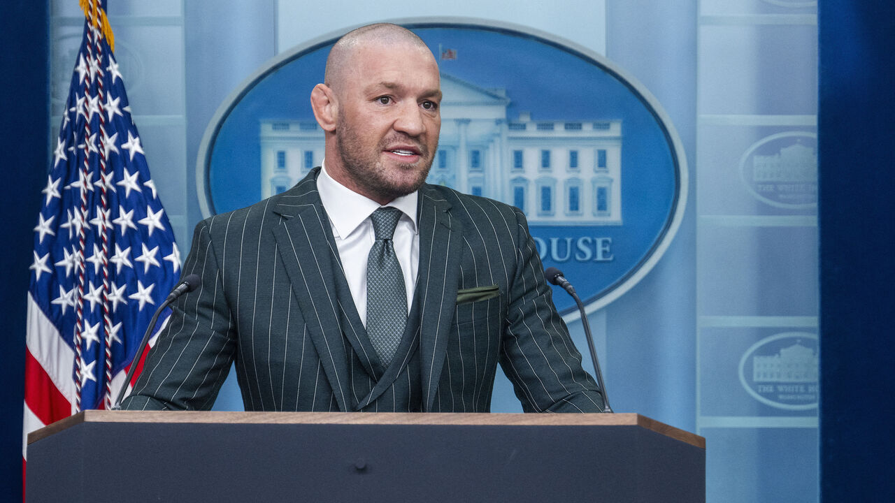 Irish professional mixed martial artist and businessman Conor McGregor (L) speaks from the White House briefing room podium with White House Press Secretary Karoline Leavitt (R) in Washington, DC, on March 17, 2025.