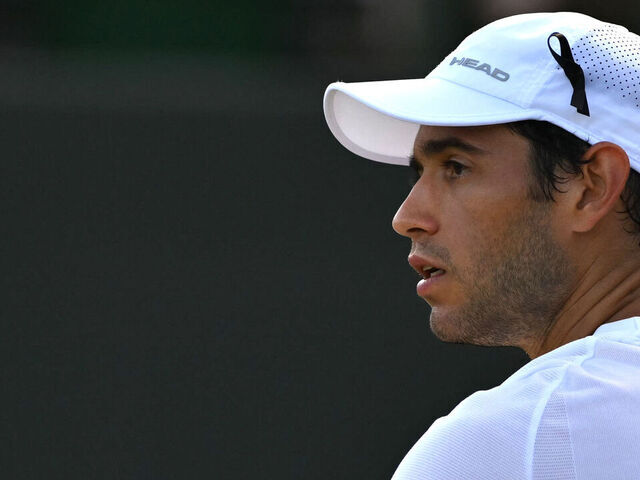 Portugal's Nuno Borges wears a black ribbon in tribute to late Portuguese football player Diogo Jota during during his men's singles third round tennis match against Russia's Karen Khachanov on the fifth day of the 2025 Wimbledon Championships at The All England Lawn Tennis and Croquet Club in Wimbledon, southwest London, on July 4, 2025. Liverpool forward Diogo Jota and his brother Andre Silva died in a car crash in northwestern Spain early July 3, sparking widespread grief just after the Portugal star had got married.
