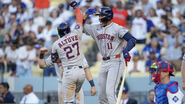 LOS ANGELES, CALIFORNIA - JULY 4: Cam Smith #11 of the Houston Astros congratulates teammate Jose Altuve #27 after Altuve hits a home run during the third inning at Dodger Stadium on July 4, 2025 in Los Angeles, California.