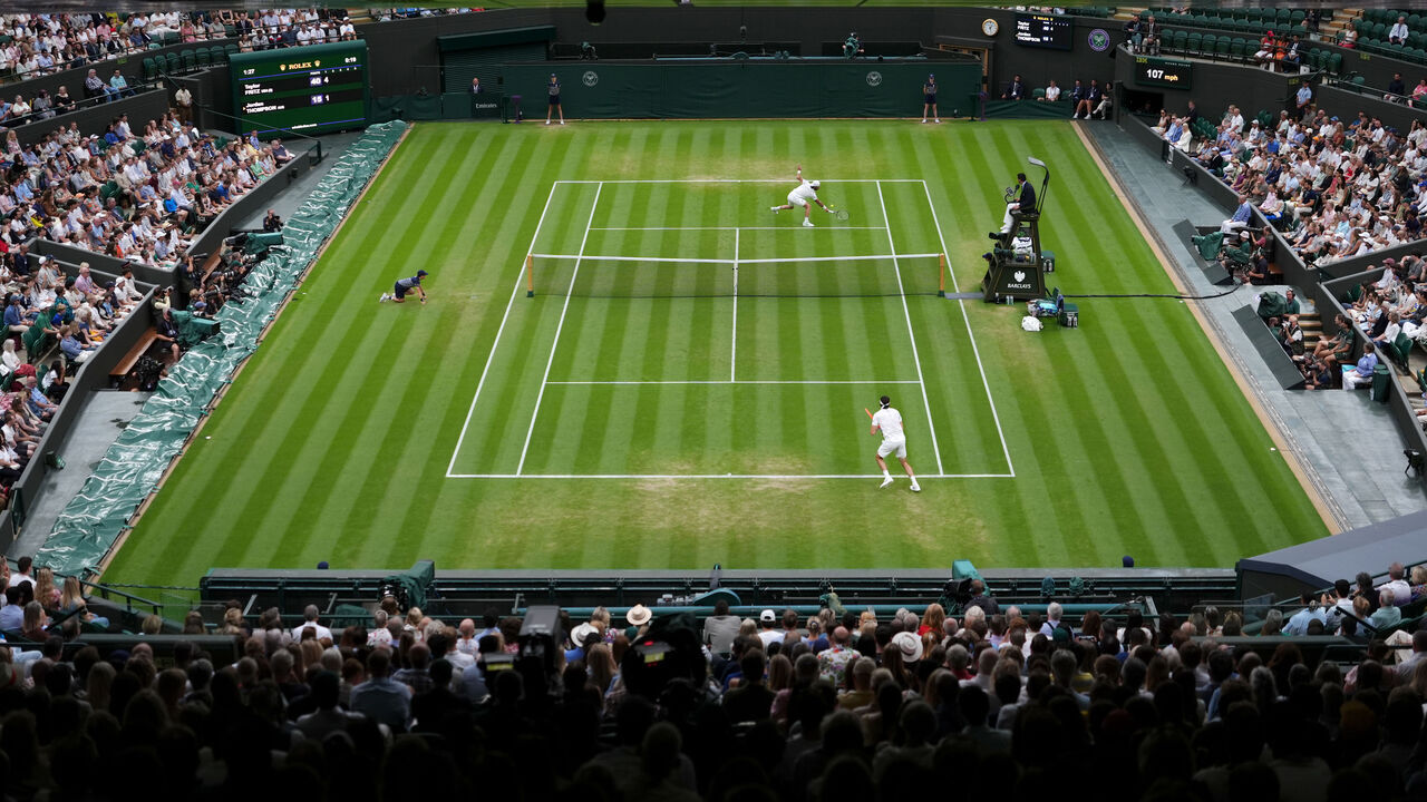 Spectators view the Gentlemen's Singles match between Jordan Thompson (top) and Taylor Fritz on day seven of the 2025 Wimbledon Championships at the All England Lawn Tennis and Croquet Club, London. Picture date: Sunday July 6, 2025.