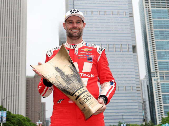 CHICAGO, ILLINOIS - JULY 06: Shane Van Gisbergen, driver of the #88 WeatherTech Chevrolet, poses with the NASCAR Chicago Street Race trophy after winning the NASCAR Cup Series Grant Park 165 at Chicago Street Course on July 06, 2025 in Chicago, Illinois.