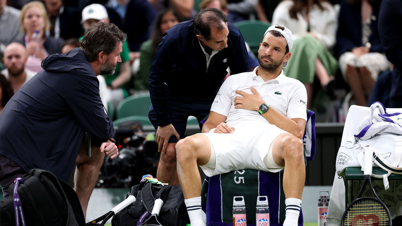 LONDON, ENGLAND - JULY 07: Grigor Dimitrov of Bulgaria reacts as he receives medical attention against Jannik Sinner of Italy during the Gentlemen's Singles fourth round match on day eight of The Championships Wimbledon 2025 at All England Lawn Tennis and Croquet Club on July 07, 2025 in London, England.