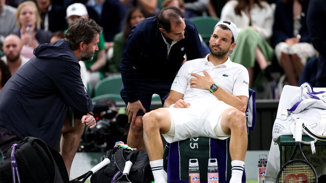 LONDON, ENGLAND - JULY 07: Grigor Dimitrov of Bulgaria reacts as he receives medical attention against Jannik Sinner of Italy during the Gentlemen's Singles fourth round match on day eight of The Championships Wimbledon 2025 at All England Lawn Tennis and Croquet Club on July 07, 2025 in London, England.