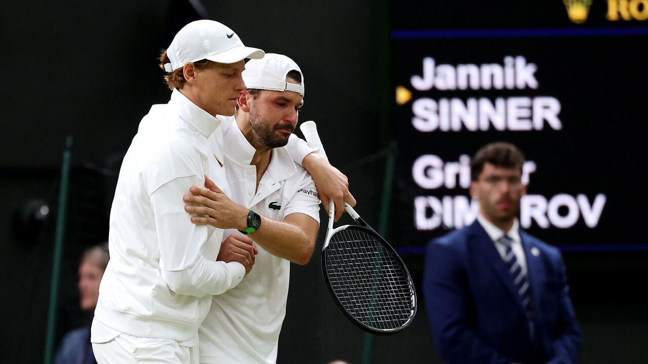 LONDON, ENGLAND - JULY 07: Jannik Sinner of Italy helps Grigor Dimitrov of Bulgaria get back to his bench after an injury during the Gentlemen's Singles fourth round match on day eight of The Championships Wimbledon 2025 at All England Lawn Tennis and Croquet Club on July 07, 2025 in London, England.