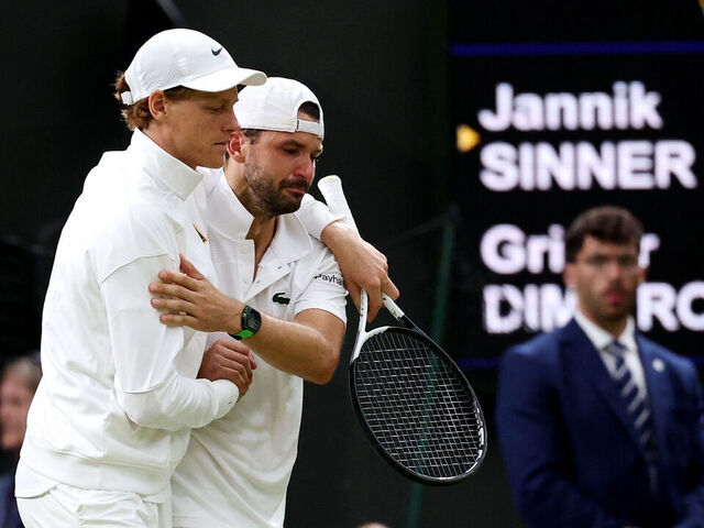 LONDON, ENGLAND - JULY 07: Jannik Sinner of Italy helps Grigor Dimitrov of Bulgaria get back to his bench after an injury during the Gentlemen's Singles fourth round match on day eight of The Championships Wimbledon 2025 at All England Lawn Tennis and Croquet Club on July 07, 2025 in London, England.