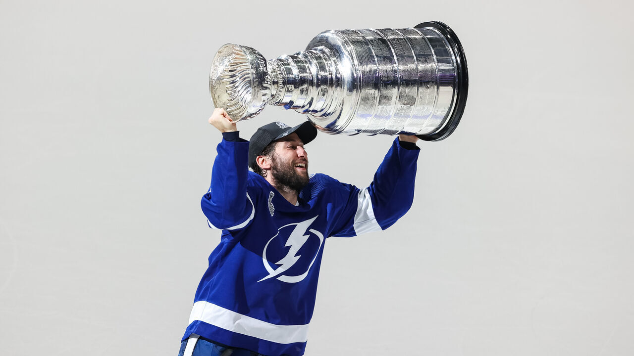 TAMPA, FL - JULY 7: Tyler Johnson #9 of the Tampa Bay Lightning hoists the Stanley Cup overhead after the Tampa Bay Lightning defeated the Montreal Canadiens in Game Five to win the best of seven game series 4-1 during the Stanley Cup Final of the 2021 Stanley Cup Playoffs at Amalie Arena on July 7, 2021 in Tampa, Florida.