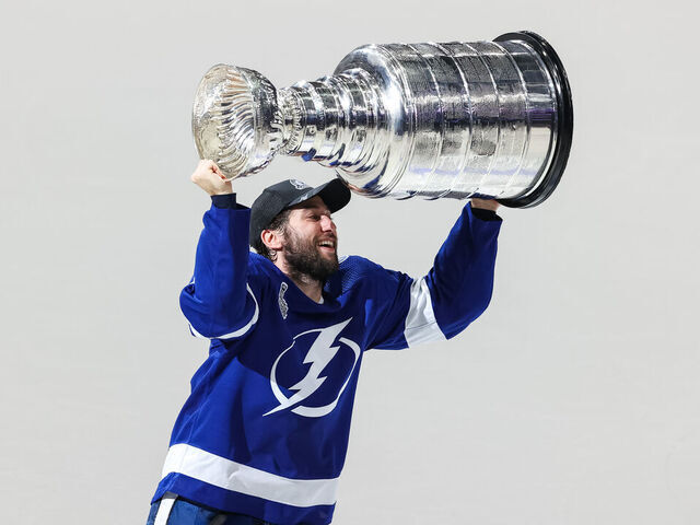 TAMPA, FL - JULY 7: Tyler Johnson #9 of the Tampa Bay Lightning hoists the Stanley Cup overhead after the Tampa Bay Lightning defeated the Montreal Canadiens in Game Five to win the best of seven game series 4-1 during the Stanley Cup Final of the 2021 Stanley Cup Playoffs at Amalie Arena on July 7, 2021 in Tampa, Florida.