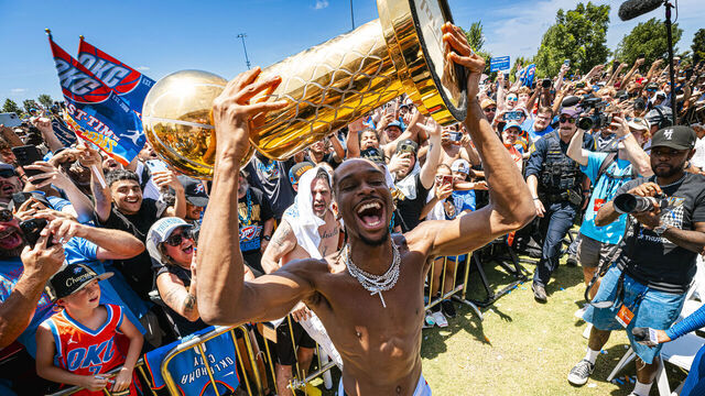 OKLAHOMA CITY, OK - JUNE 24: Shai Gilgeous-Alexander #2 of the Oklahoma City Thunder celebrates while holding the trophy during the 2025 Oklahoma City Thunder championship parade on June 24, 2025 in Oklahoma City, Oklahoma. Mandatory Copyright Notice: Copyright 2025 NBAE