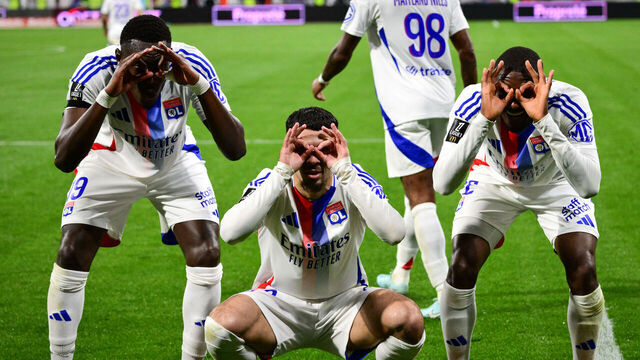 Lyon's Georgian forward #69 Georges Mikautadze (C) celebrates with Lyon's Senegalese defender #19 Moussa Niakhate (L) and Lyon's Angolan defender #22 Clinton Mata after scoring his team's fourth goal during the French L1 football match between Olympique Lyonnais (OL) and Stade Rennais FC (Rennes) at The Groupama Stadium in Decines-Charpieu, central-eastern France on April 26, 2025.