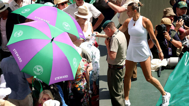 LONDON, ENGLAND - JULY 10: Aryna Sabalenka gives water to a member of the crowd during the Ladies' Singles semi-final against Amanda Anisimova of United States on day eleven of The Championships Wimbledon 2025 at All England Lawn Tennis and Croquet Club on July 10, 2025 in London, England.