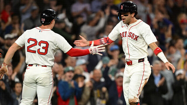 BOSTON, MASSACHUSETTS - JULY 10: Marcelo Mayer #39 of the Boston Red Sox celebrates with Romy Gonzalez #23 after scoring a run against the Tampa Bay Rays during the seventh inning at Fenway Park on July 10, 2025 in Boston, Massachusetts.