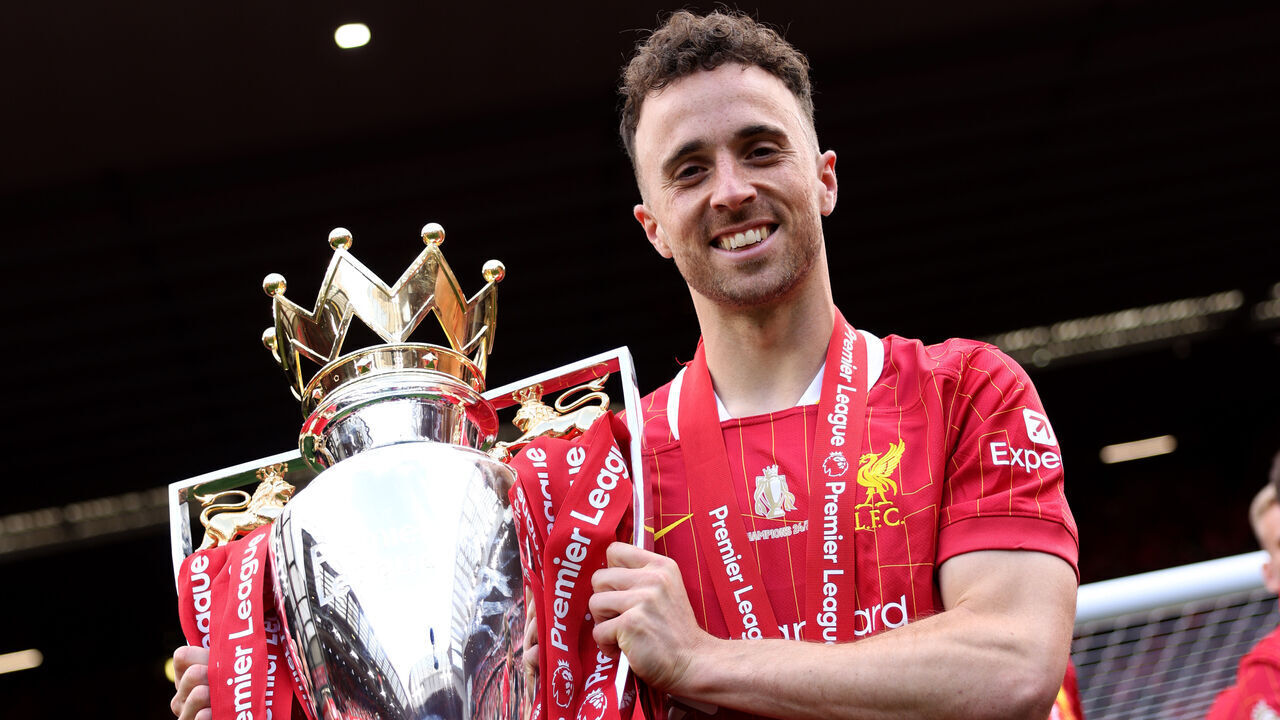 LIVERPOOL, ENGLAND - MAY 25: (THE SUN OUT. THE SUN ON SUNDAY OUT) Diogo Jota of Liverpool poses for a photograph with the Premier League trophy, as Liverpool are crowned the Champions of the Premier League, following the Premier League match between Liverpool FC and Crystal Palace FC at Anfield on May 25, 2025 in Liverpool, England.