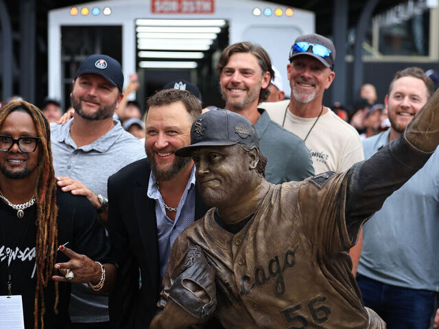 CHICAGO, ILLINOIS - JULY 11: Former Chicago White Sox pitcher Mark Buehrle and members of the 2005 World Series winning Chicago White Sox team pose for a picture in front of a statue unveiled in Buehrle's honor before game two of a doubleheader against the Cleveland Guardians at Rate Field on July 11, 2025 in Chicago, Illinois.
