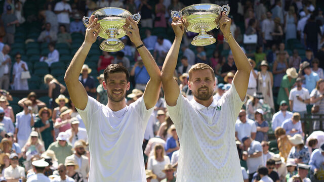 LONDON, ENGLAND - JULY 12: Julian Cash of Great Britain and Lloyd Glasspool of Great Britain hold the Gentlemen's Doubles Trophy after beating Rinky Hijikata of Australia and David Pel of the Netherlands in the Gentlemen's Doubles final on Centre Court on day thirteen of The Championships Wimbledon 2025 at All England Lawn Tennis and Croquet Club on July 12, 2025 in London, England.