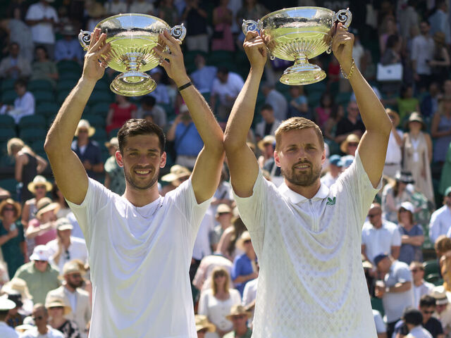 LONDON, ENGLAND - JULY 12: Julian Cash of Great Britain and Lloyd Glasspool of Great Britain hold the Gentlemen's Doubles Trophy after beating Rinky Hijikata of Australia and David Pel of the Netherlands in the Gentlemen's Doubles final on Centre Court on day thirteen of The Championships Wimbledon 2025 at All England Lawn Tennis and Croquet Club on July 12, 2025 in London, England.