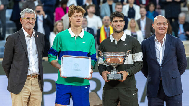 PARIS, FRANCE - JUNE 8: Gilles Moretton, President of the French Tennis Federation, Carlos Alcaraz of Spain with the winners trophy, Jannik Sinner of Italy with the runners-up trophy and Andre Agassi who presented the trophies, at the trophy presentations after the Final of the Men's singles competition on Court Philippe-Chatrier during the 2025 French Open Tennis Tournament at Roland Garros on June 8th, 2025, in Paris, France.
