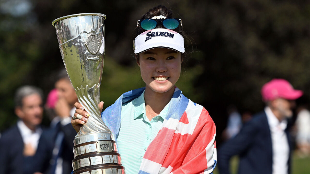 EVIAN-LES-BAINS, FRANCE - JULY 13: Grace Kim of Australia poses for a photograph with The Amundi Evian Championship 2025 trophy whilst wearing the national flag of Australia, after defeating Jeeno Thitikul of Thailand in the play-off, following the final round of The Amundi Evian Championship 2025 at Evian Resort Golf Club on July 13, 2025 in Evian-les-Bains, France.
