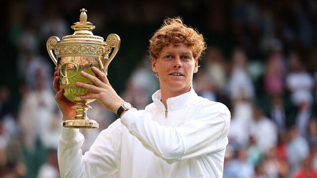 Italy's Jannik Sinner celebrates with the winner's trophy as he poses for pictures following his victory against Spain's Carlos Alcaraz at the end of their men's singles final tennis match on the fourteenth day of the 2025 Wimbledon Championships at The All England Lawn Tennis and Croquet Club in Wimbledon, southwest London, on July 13, 2025.