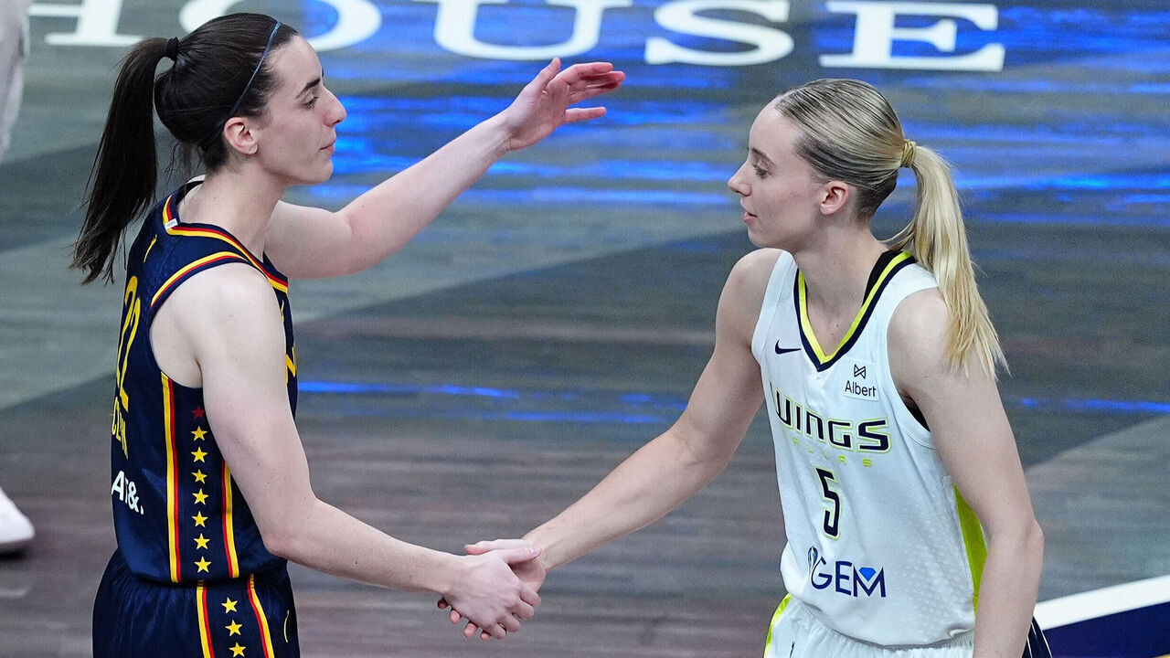 INDIANAPOLIS, IN - JULY 13: Indiana Fever Caitlin Clark (22) before the game hugs Dallas Wings guard Paige Bueckers (5) on July 13, 2025, at Gainbridge Fieldhouse in Indianapolis, Indiana.