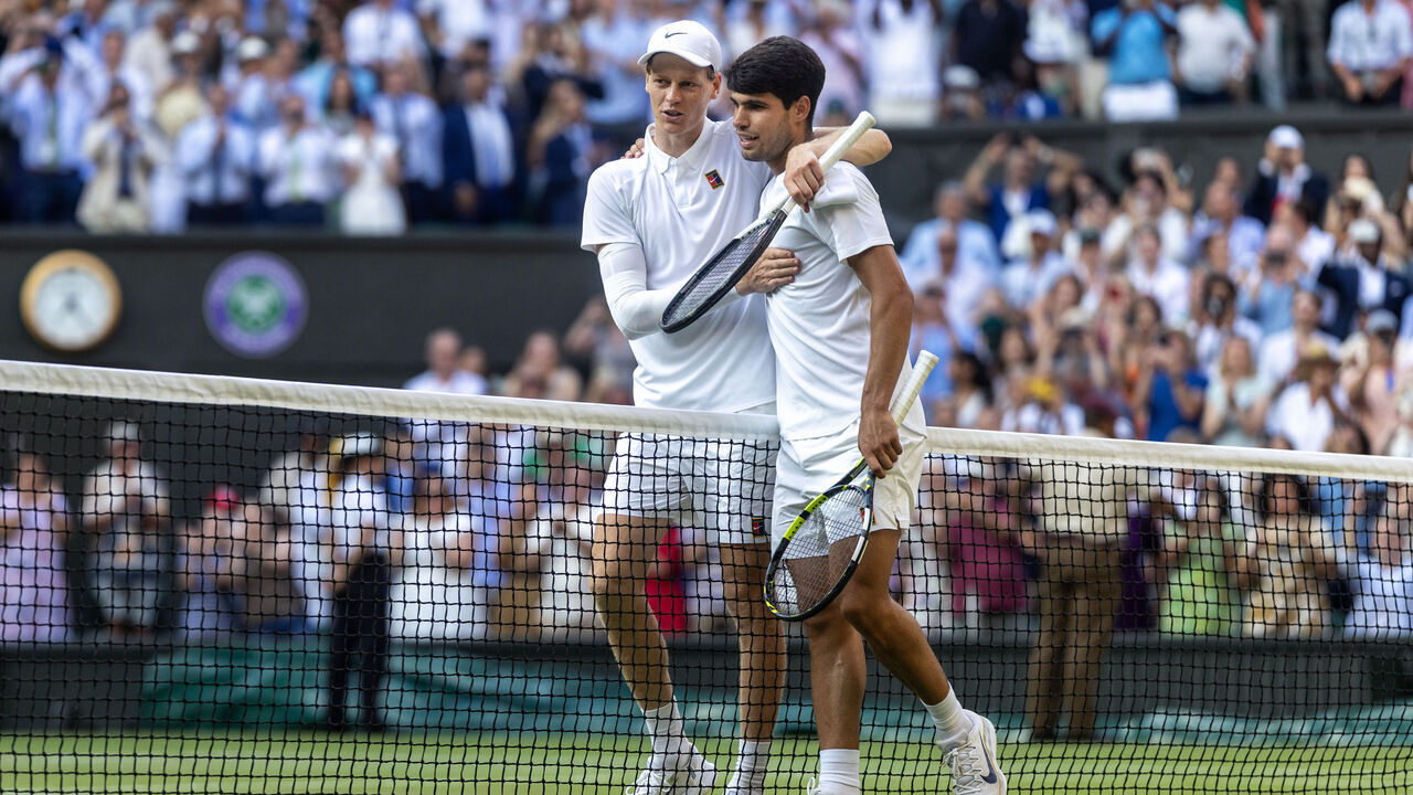LONDON, ENGLAND - JULY 13: Winner Jannik Sinner of Italy and Carlos Alcaraz of Spain embrace at the net after the Gentlemen's Singles Final on Centre Court during the Wimbledon Lawn Tennis Championships at the All England Lawn Tennis and Croquet Club at Wimbledon on July 13th, 2025, in London, England.
