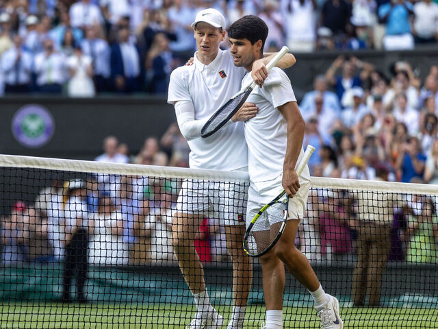 LONDON, ENGLAND - JULY 13: Winner Jannik Sinner of Italy and Carlos Alcaraz of Spain embrace at the net after the Gentlemen's Singles Final on Centre Court during the Wimbledon Lawn Tennis Championships at the All England Lawn Tennis and Croquet Club at Wimbledon on July 13th, 2025, in London, England.