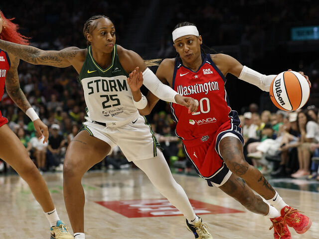 SEATTLE, WASHINGTON - JULY 13: Brittney Sykes #20 of the Washington Mystics dribbles the ball against Tiffany Mitchell #25 of the Seattle Storm during the fourth quarter of the game at Climate Pledge Arena on July 13, 2025 in Seattle, Washington. The Washington Mystics won 74-69.