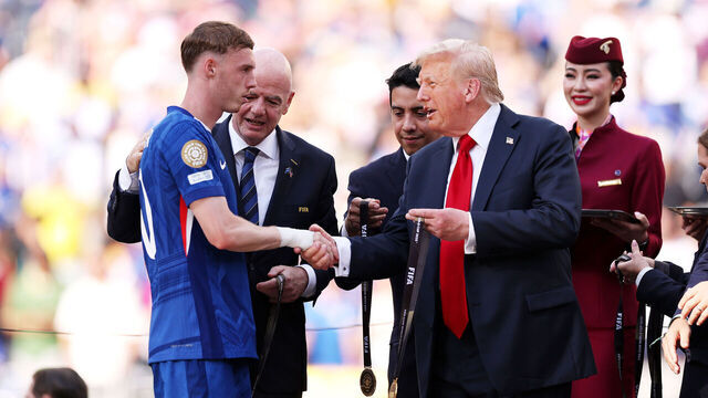 EAST RUTHERFORD, NEW JERSEY - JULY 13: Cole Palmer #10 of Chelsea FC collects his Gold Medal from U.S. President Donald Trump and Gianni Infantino, President of FIFA, following the FIFA Club World Cup 2025 Final match between Chelsea FC and Paris Saint-Germain at MetLife Stadium on July 13, 2025 in East Rutherford, New Jersey.