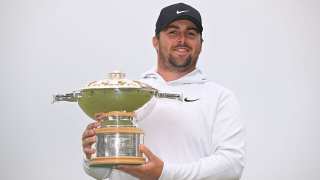 NORTH BERWICK, SCOTLAND - JULY 13: Chris Gotterup of the United States holds the trophy on the 18th green after the final round of Genesis Scottish Open at The Renaissance Club on July 13, 2025 in North Berwick, Scotland.