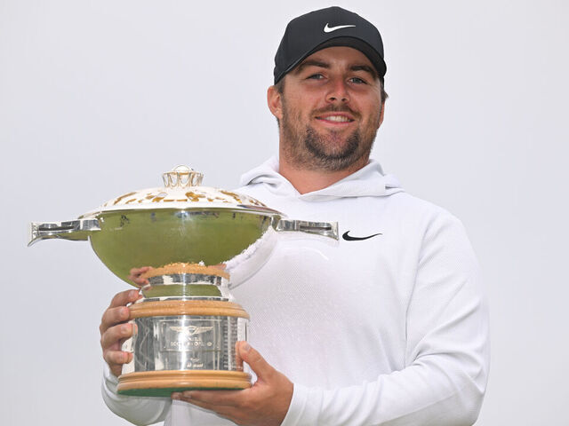 NORTH BERWICK, SCOTLAND - JULY 13: Chris Gotterup of the United States holds the trophy on the 18th green after the final round of Genesis Scottish Open at The Renaissance Club on July 13, 2025 in North Berwick, Scotland.