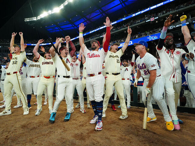ATLANTA, GA - JULY 15: Kyle Schwarber #12 of the Philadelphia Phillies celebrates with teammates after hitting three home runs in three swings to win the Inaugural All-Star Game Swingoff Presented by Geico and win the 95th MLB All-Star Game presented by Mastercard at Truist Park on Tuesday, July 15, 2025 in Atlanta, Georgia.