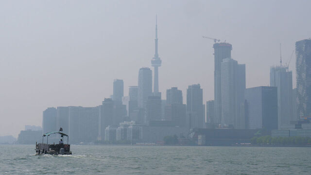 Smoke from wildfires blankets the Toronto skyline, seen from Polson Pier, in Toronto, Canada, on July 14, 2025. Environment Canada issues an air quality warning as smoke from northern Ontario wildfires drifts south, combining with extreme heat to create hazardous conditions across the region.